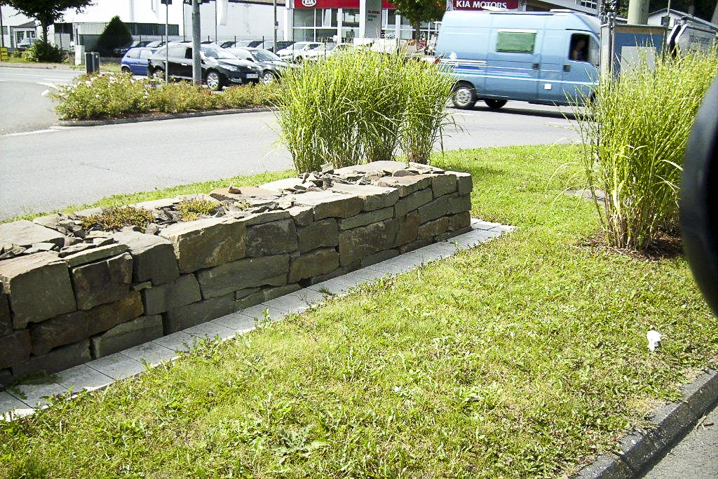Natursteinmauer mit Gräserbepflanzung